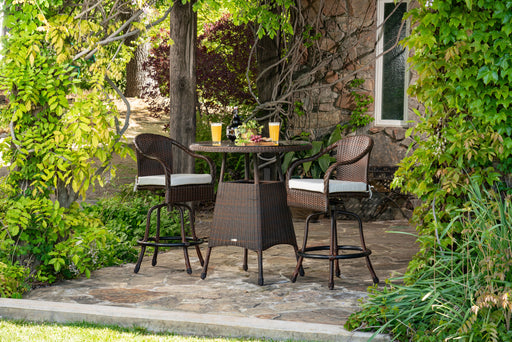 A durable Tortuga Outdoor Sea Pines 3-Piece Wicker Bar Set - Java or Mojave with a table and chairs.
