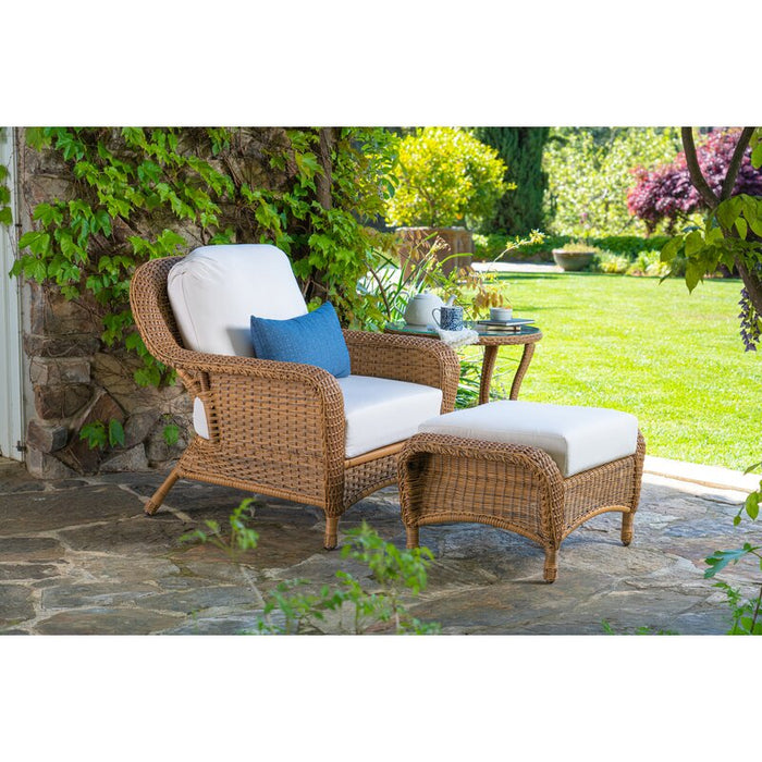 A Tortuga Outdoor Sea Pines 3-Piece Outdoor Wicker Seating Set - Mojave on a patio.