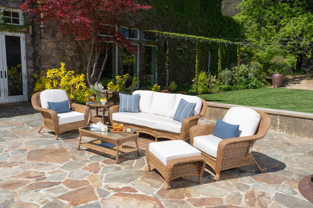 An outdoor living space with an all-weather Tortuga Outdoor Sea Pines 6-Piece Seating Set with Sofa - Mojave.