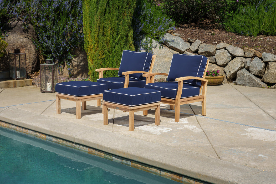 The Tortuga Outdoor 4-Piece Indonesian Teak Club Chair Set - Sunbrella Canvas Natural or Navy is sitting by a pool.