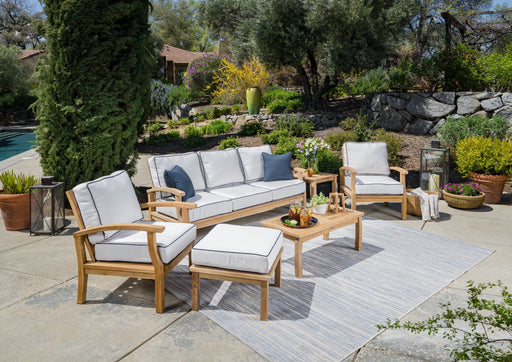 A Tortuga Outdoor 6-Piece Indonesian Teak Sofa Set with Sunbrella Canvas Natural or Navy cushions.