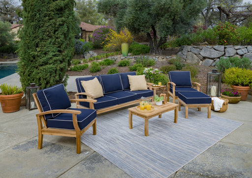A Tortuga Outdoor 6-Piece Indonesian Teak Sofa Set with Sunbrella Canvas Natural or Navy cushions and outdoor seating.