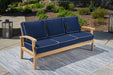 Transform your patio into a luxury retreat with the Tortuga Outdoor 6-Piece Indonesian Teak Sofa and Fire Table Set. This outdoor sofa features vibrant blue cushions that perfectly complement the stunning rug underneath. Relax, unwind