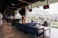 Indoor golf bay at Top Golf Monterrey with ceiling-mounted Tungsten Smart-Heat 500 series gas heaters providing warmth.