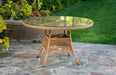 The table from the Tortuga Outdoor Sea Pines 5-Piece Outdoor Wicker Conversation Set - Mojave placed on a patio.