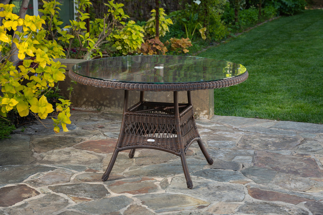 The table from the Tortuga Outdoor Sea Pines 5-Piece Outdoor Wicker Conversation Set - Java on a patio