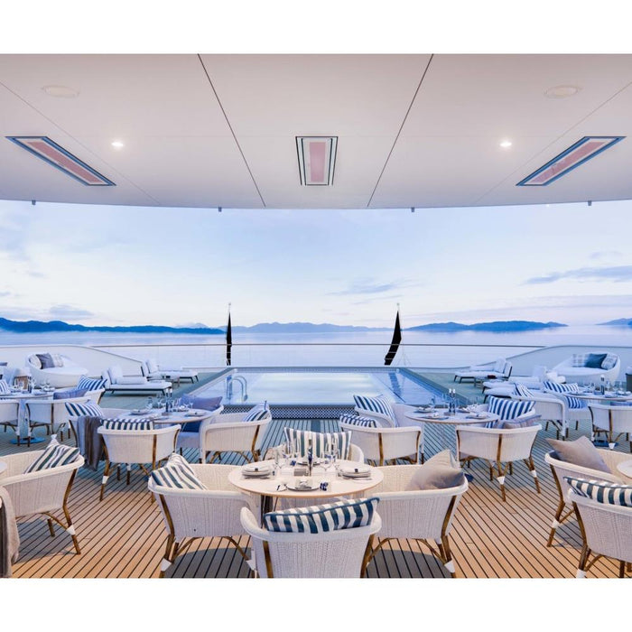 Spacious outdoor dining area on a ship deck featuring Bromic Heating's Platinum 3400W marine grade electric heater, creating a comfortable environment for guests.