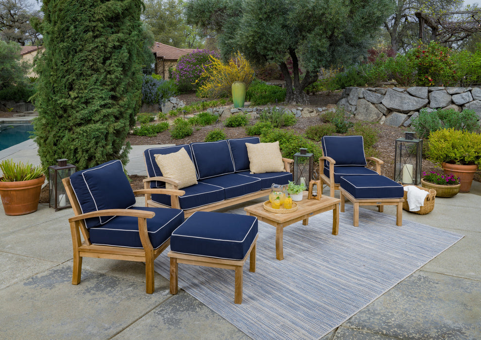 A durable Tortuga Outdoor 6-Piece Indonesian Teak Outdoor Sofa Set with Sunbrella Navy cushions.