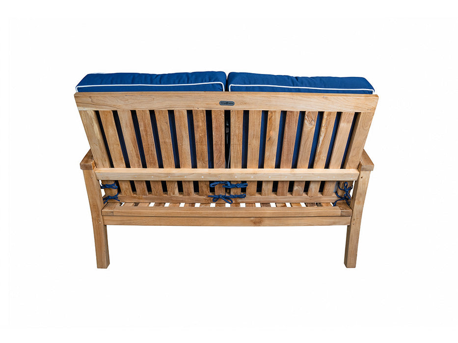 A durable Tortuga Outdoor wooden bench with a blue cushion.