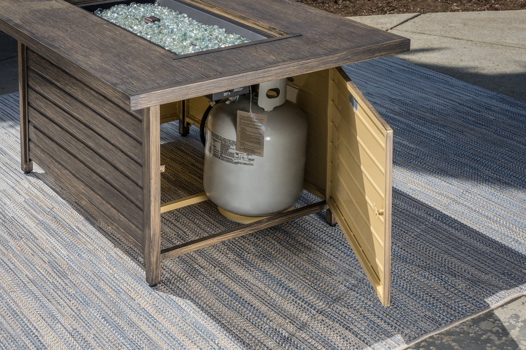 A durable Tortuga Outdoor fire pit with a propane tank.