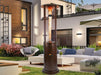 Brown  Helios Tower Heater in a garden patio setting.