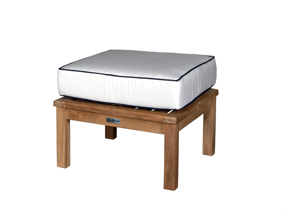 A durable Tortuga Outdoor wooden ottoman with a cushion on top.