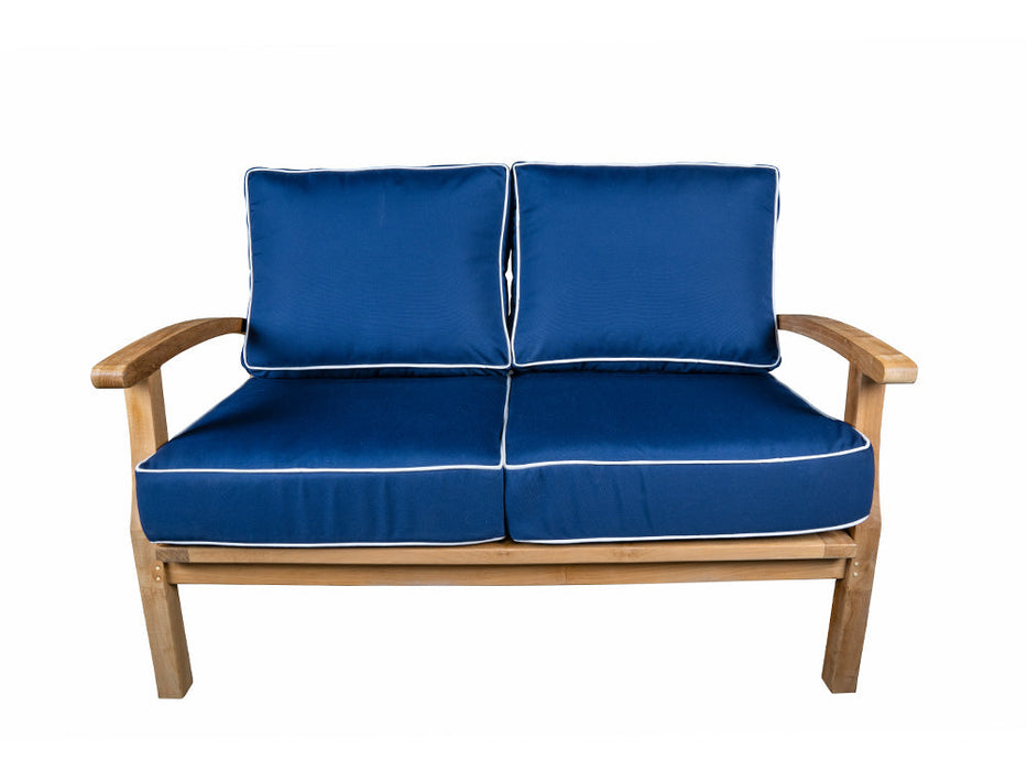 A Tortuga Outdoor blue and white loveseat with durable construction and a wooden frame.