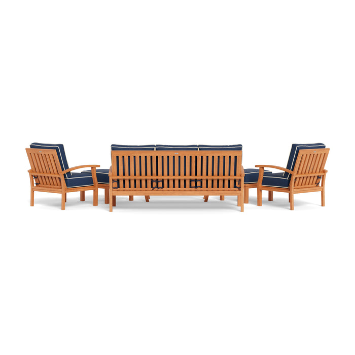 A durable Tortuga Outdoor teak outdoor furniture set with blue cushions.