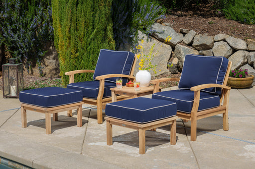 A Tortuga Outdoor 5-Piece Indonesian Teak Club Chair Set with Sunbrella Canvas Natural or Navy cushions, perfect for your patio.