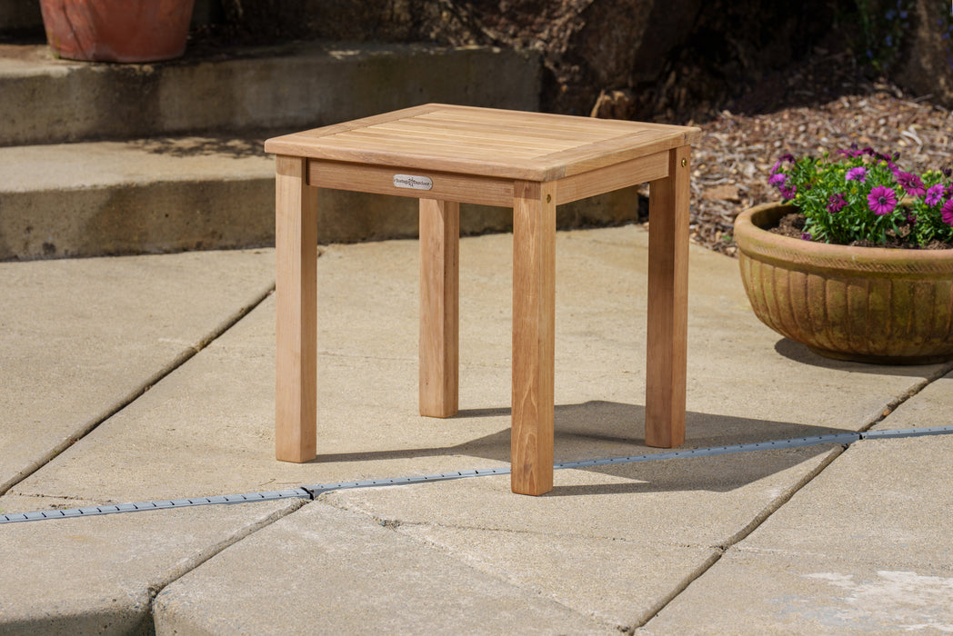 A Tortuga Outdoor 5-Piece Indonesian Teak Loveseat Set - Sunbrella Canvas Natural or Navy on a patio.